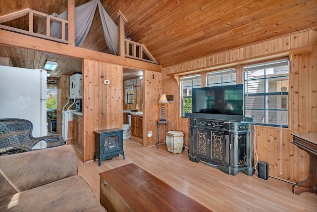 1 Dinosaur Rd, Wilmington, IL 60481 - living room featuring a wood stove, wooden walls, lofted ceiling, and wood finished floors