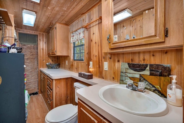 1 Dinosaur Rd, Wilmington, IL 60481 - bathroom with toilet, vanity, wood finished floors, wood ceiling, and wood walls