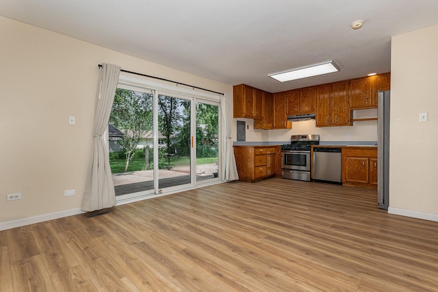 931 Mosby Ct, Joliet, IL 60431 - kitchen with appliances with stainless steel finishes, under cabinet range hood, light wood-type flooring, brown cabinetry, and baseboards