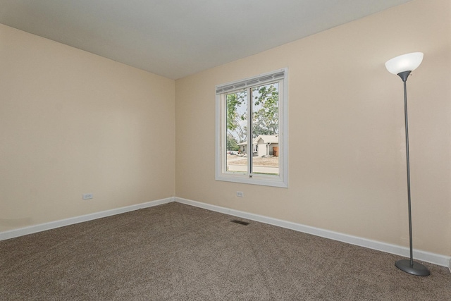 931 Mosby Ct, Joliet, IL 60431 - unfurnished room with dark carpet and baseboards