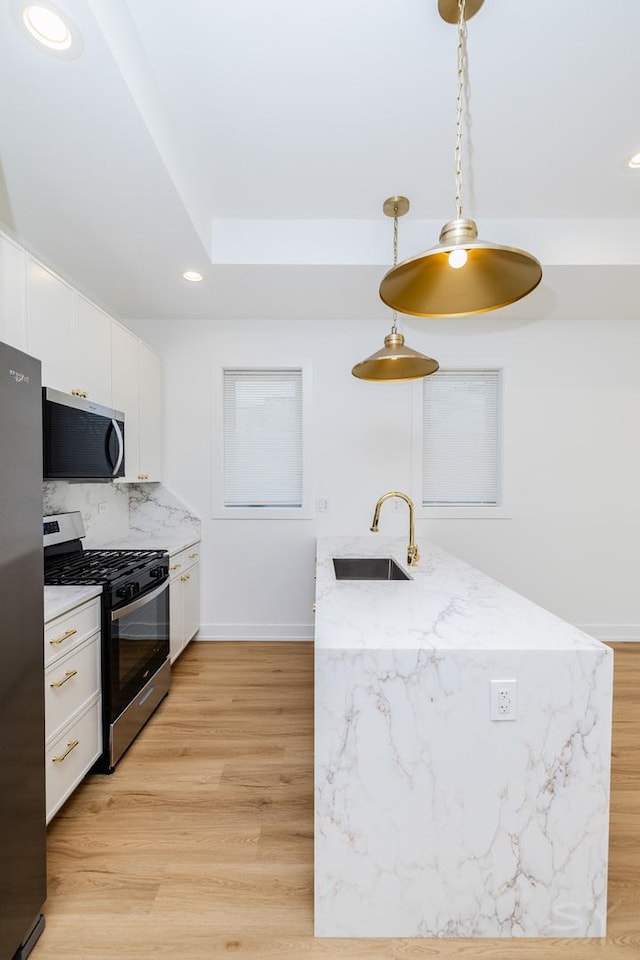 6048 S Eberhart Ave, Chicago, IL 60637 - kitchen with appliances with stainless steel finishes, a sink, white cabinetry, recessed lighting, and light wood finished floors