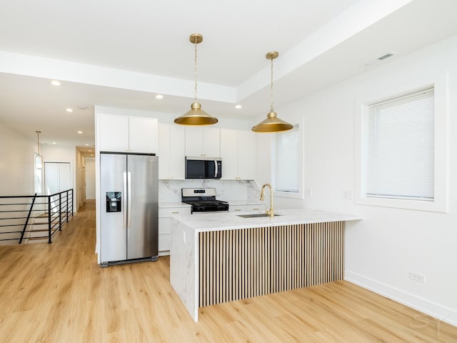 6048 S Eberhart Ave, Chicago, IL 60637 - kitchen featuring appliances with stainless steel finishes, a sink, light wood-type flooring, white cabinetry, and recessed lighting