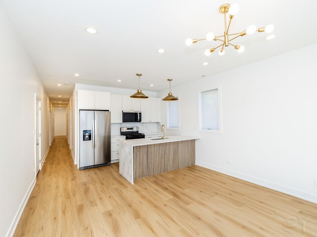 6048 S Eberhart Ave, Chicago, IL 60637 - kitchen featuring stainless steel appliances, a sink, recessed lighting, a chandelier, and light wood finished floors