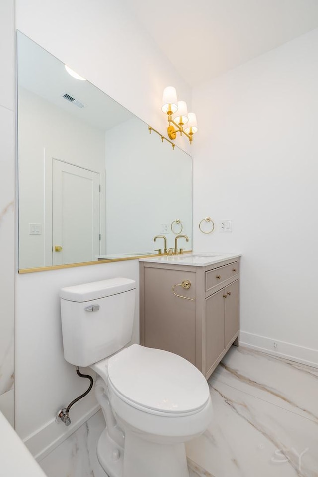 6048 S Eberhart Ave, Chicago, IL 60637 - bathroom featuring marble finish flooring, toilet, vanity, baseboards, and a chandelier