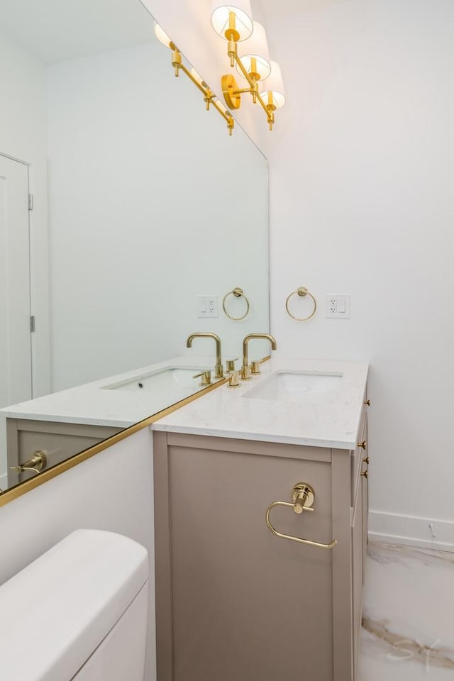 6048 S Eberhart Ave, Chicago, IL 60637 - bathroom with vanity, toilet, a chandelier, and baseboards