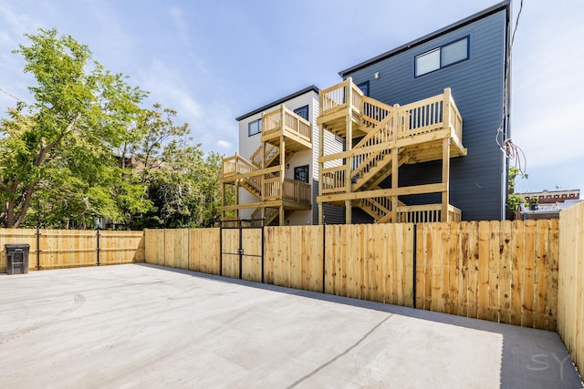 6048 S Eberhart Ave, Chicago, IL 60637 - rear view of property featuring a fenced backyard, a wooden deck, and stairs