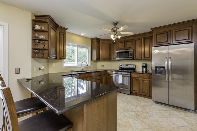 1161 Sumner Cir, Gurnee, IL 60031 - kitchen with appliances with stainless steel finishes, open shelves, a peninsula, a sink, and dark stone counters