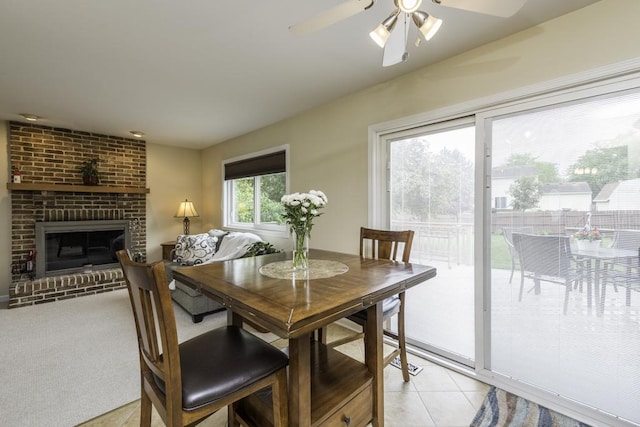 1161 Sumner Cir, Gurnee, IL 60031 - dining room with ceiling fan, light tile patterned floors, and a fireplace