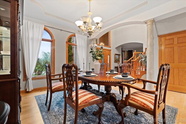 13851 S Janas Pkwy, Homer Glen, IL 60491 - dining space with arched walkways, a chandelier, light wood-type flooring, and stairway