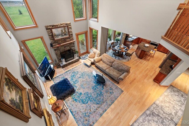 13851 S Janas Pkwy, Homer Glen, IL 60491 - living area with a high ceiling, wood finished floors, and a stone fireplace