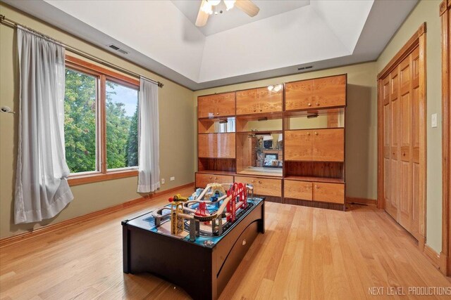 13851 S Janas Pkwy, Homer Glen, IL 60491 - recreation room featuring light wood-style flooring, baseboards, a tray ceiling, and a ceiling fan