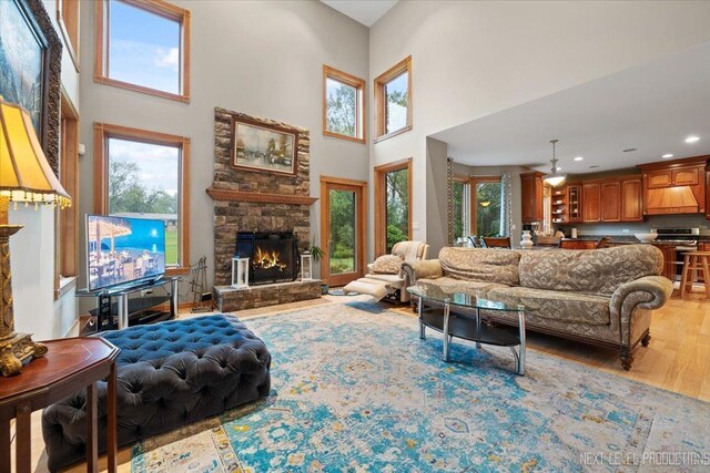 13851 S Janas Pkwy, Homer Glen, IL 60491 - living room featuring a towering ceiling, a fireplace, plenty of natural light, wood finished floors, and recessed lighting