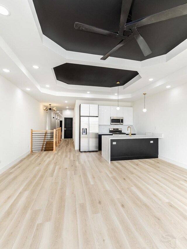 5534 S Michigan Ave, Chicago, IL 60637 - kitchen featuring appliances with stainless steel finishes, a tray ceiling, white cabinetry, baseboards, and recessed lighting