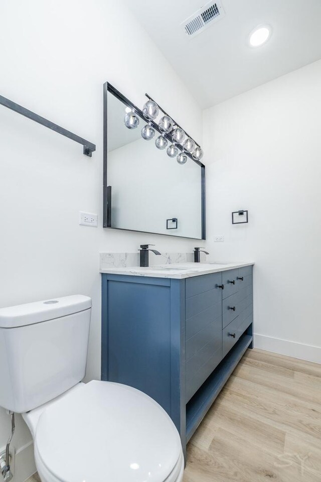 5534 S Michigan Ave, Chicago, IL 60637 - bathroom featuring toilet, double vanity, wood finished floors, baseboards, and recessed lighting