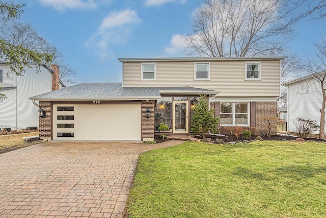 274 University Dr, Buffalo Grove, IL 60089 - view of front of property featuring brick siding, a garage, decorative driveway, a front yard, and a shingled roof