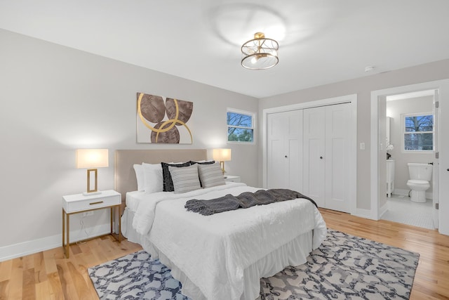 274 University Dr, Buffalo Grove, IL 60089 - bedroom with light wood-style floors, a closet, baseboards, and connected bathroom