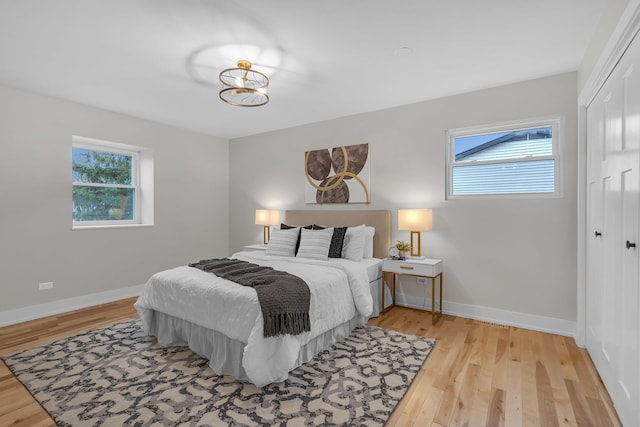 274 University Dr, Buffalo Grove, IL 60089 - bedroom with a closet, light wood-style flooring, and baseboards