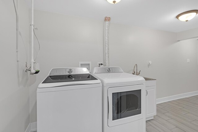 274 University Dr, Buffalo Grove, IL 60089 - laundry room with separate washer and dryer, cabinet space, baseboards, and light wood finished floors