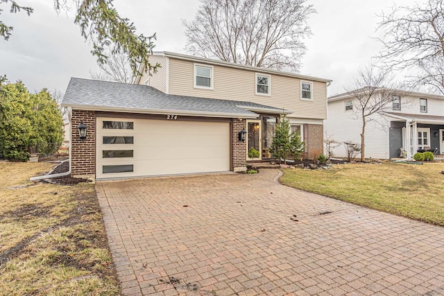274 University Dr, Buffalo Grove, IL 60089 - view of front of property with brick siding, decorative driveway, a front yard, and a shingled roof