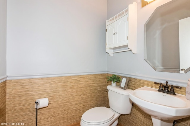 773 Pheasant Trl Unit 773, Saint Charles, IL 60174 - half bathroom with toilet, a wainscoted wall, tile walls, and a sink