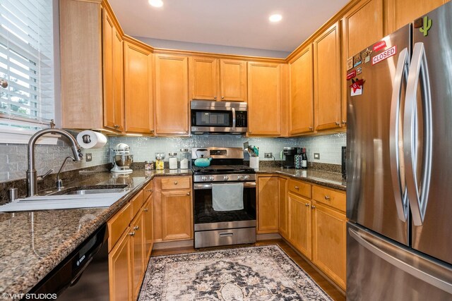 773 Pheasant Trl Unit 773, Saint Charles, IL 60174 - kitchen featuring appliances with stainless steel finishes, a sink, decorative backsplash, dark stone counters, and recessed lighting