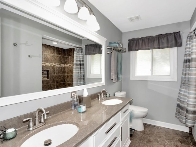14802 Anne Ct, Oak Forest, IL 60452 - bathroom with toilet, double vanity, a tile shower, and baseboards