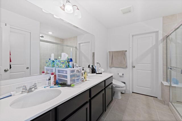404 Radcliff Ln, South Elgin, IL 60177 - bathroom featuring double vanity, a stall shower, tile patterned flooring, and toilet