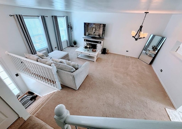 915 Manchester Cir, Grayslake, IL 60030 - carpeted living area with plenty of natural light, a chandelier, and baseboards