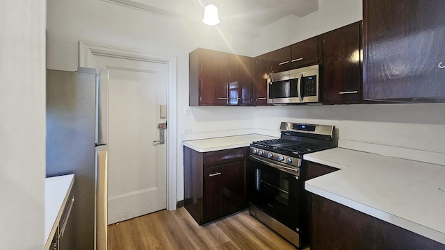 5000 S Cornell Ave Unit 6C, Chicago, IL 60615 - kitchen with stainless steel appliances, light wood-style flooring, light countertops, and dark brown cabinets