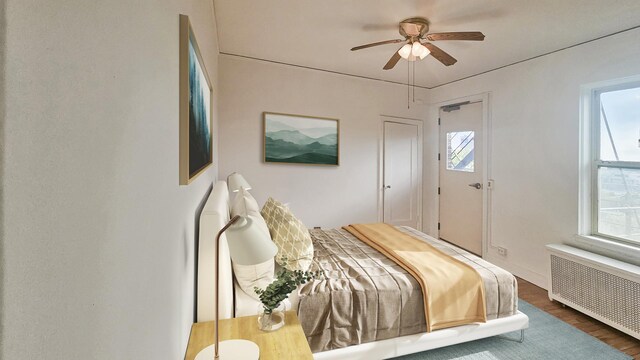 5000 S Cornell Ave Unit 6C, Chicago, IL 60615 - bedroom featuring radiator, wood finished floors, and ceiling fan