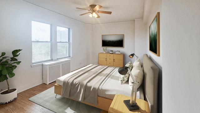 5000 S Cornell Ave Unit 6C, Chicago, IL 60615 - bedroom with radiator heating unit, baseboards, wood finished floors, and ceiling fan