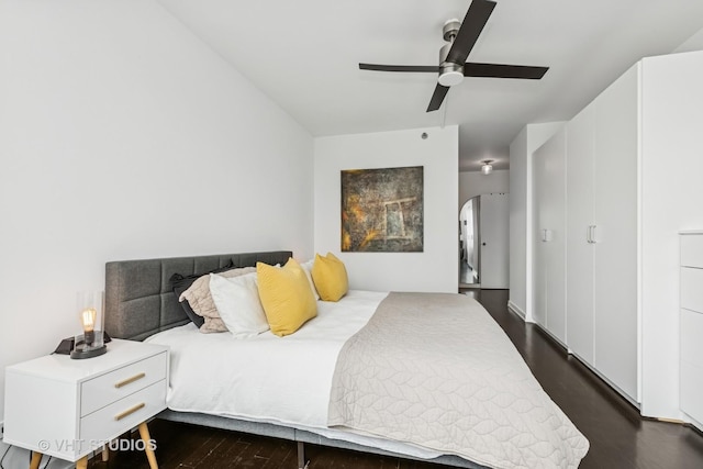 501 N Clinton St Unit 1804, Chicago, IL 60654 - bedroom with dark wood-style floors, arched walkways, and a ceiling fan