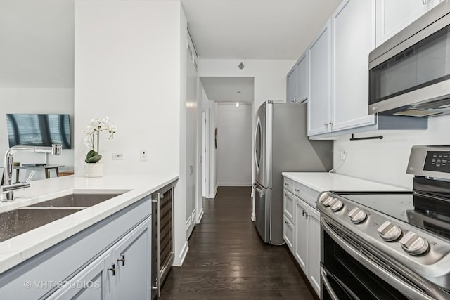 501 N Clinton St Unit 1804, Chicago, IL 60654 - kitchen featuring stainless steel appliances, dark wood-style flooring, beverage cooler, and light stone countertops
