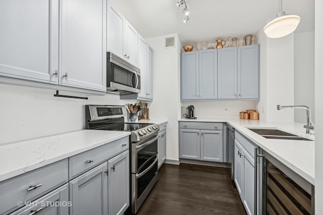 501 N Clinton St Unit 1804, Chicago, IL 60654 - kitchen featuring appliances with stainless steel finishes, wine cooler, dark wood-style flooring, gray cabinetry, and hanging light fixtures