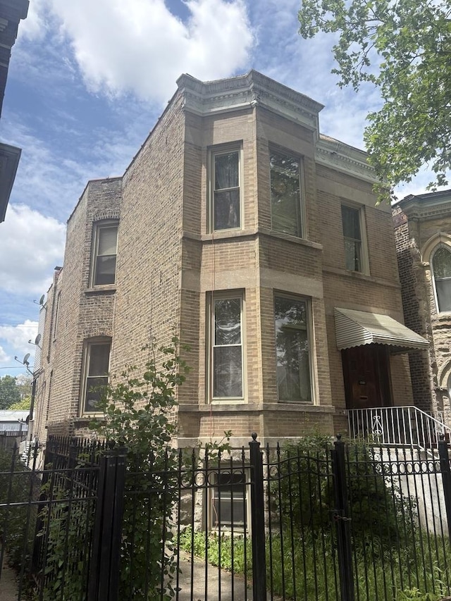 1530 N Springfield Ave, Chicago, IL 60651 - view of front of home with brick siding, a fenced front yard, and a gate