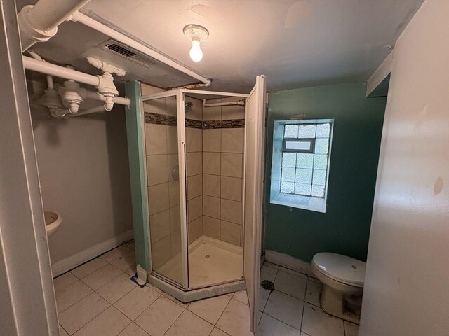 1530 N Springfield Ave, Chicago, IL 60651 - bathroom with toilet, a shower stall, tile patterned flooring, and baseboards