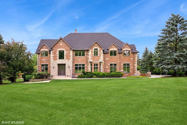 26 Forest Ln, South Barrington, IL 60010 - view of front of property with a front lawn, brick siding, and a chimney