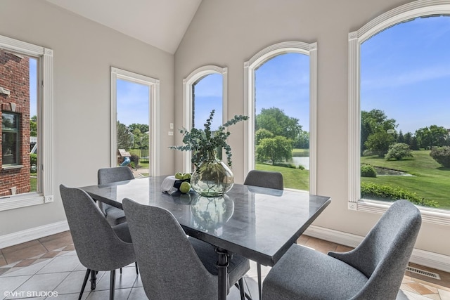 26 Forest Ln, South Barrington, IL 60010 - dining area with lofted ceiling, light tile patterned flooring, and a water view