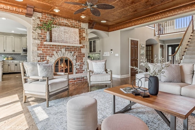 26 Forest Ln, South Barrington, IL 60010 - living room featuring an ornate ceiling, a brick fireplace, stairway, ceiling fan, and light wood-style flooring