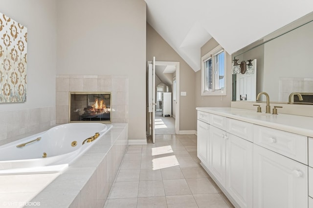 26 Forest Ln, South Barrington, IL 60010 - bathroom with vanity, a jetted tub, tile patterned floors, a tiled fireplace, and lofted ceiling