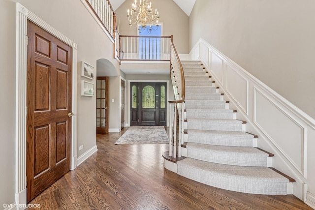 26 Forest Ln, South Barrington, IL 60010 - foyer entrance featuring stairs, arched walkways, high vaulted ceiling, wood finished floors, and a chandelier