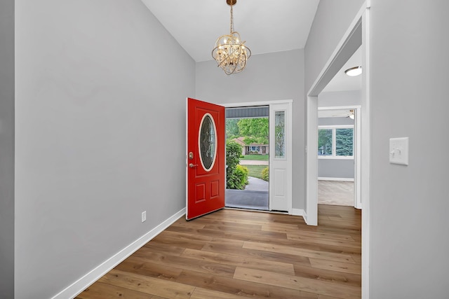 405 S Carol Ln, Braidwood, IL 60408 - foyer with a chandelier, wood-type flooring, baseboards, and a towering ceiling
