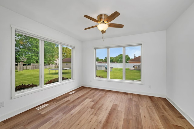 405 S Carol Ln, Braidwood, IL 60408 - unfurnished room featuring baseboards, plenty of natural light, light wood finished floors, and a ceiling fan