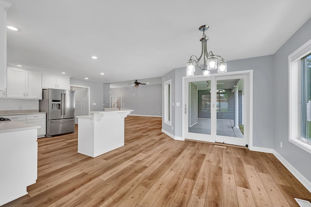 405 S Carol Ln, Braidwood, IL 60408 - kitchen featuring stainless steel fridge with ice dispenser, light countertops, light wood finished floors, baseboards, and white cabinetry