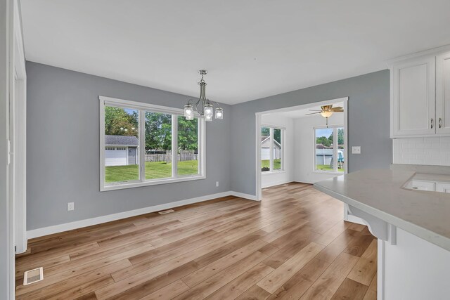405 S Carol Ln, Braidwood, IL 60408 - unfurnished dining area featuring baseboards, a chandelier, and light wood-style flooring