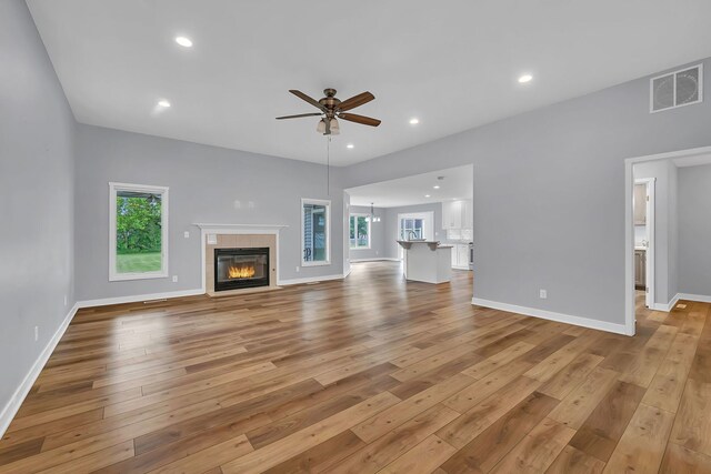 405 S Carol Ln, Braidwood, IL 60408 - unfurnished living room with ceiling fan, light wood-style floors, a fireplace, baseboards, and recessed lighting