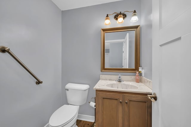 405 S Carol Ln, Braidwood, IL 60408 - half bathroom with toilet, vanity, wood finished floors, and baseboards