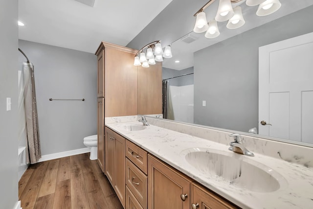 405 S Carol Ln, Braidwood, IL 60408 - bathroom featuring double vanity, toilet, wood finished floors, shower / bath combo, and baseboards