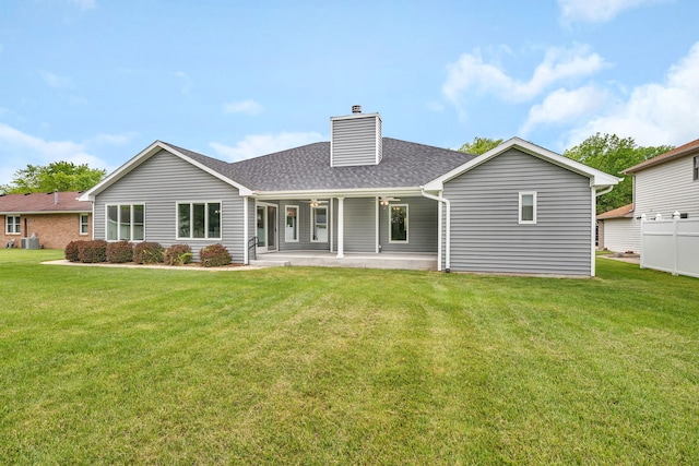 405 S Carol Ln, Braidwood, IL 60408 - rear view of house with a chimney, roof with shingles, a lawn, and ceiling fan