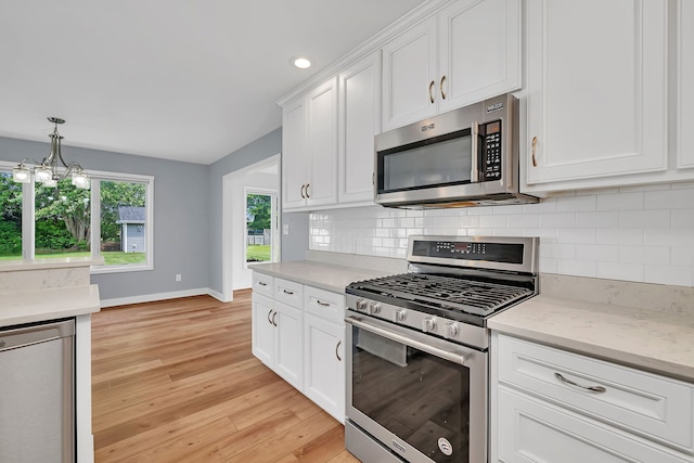 405 S Carol Ln, Braidwood, IL 60408 - kitchen with appliances with stainless steel finishes, baseboards, white cabinets, tasteful backsplash, and light wood-type flooring